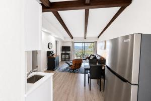 a kitchen with a refrigerator and a living room at Happy Harbor at Kimberling Crossing in Kimberling City