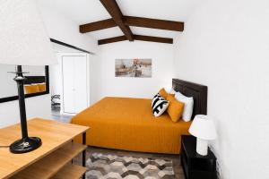 a bedroom with a bed with orange sheets and pillows at Happy Harbor at Kimberling Crossing in Kimberling City +35 photos