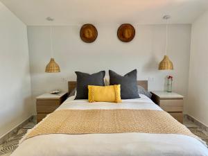 a bedroom with a large bed with two night stands at Casa A Codela in Combarro