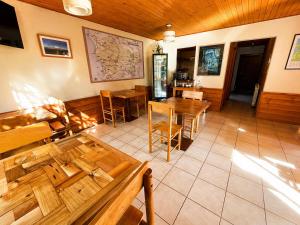 a dining room with wooden tables and chairs at Hotel El Coihue in Pucón +29 photos