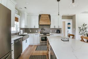 a kitchen with white cabinets and a large white counter top at Afton Awaits in Afton