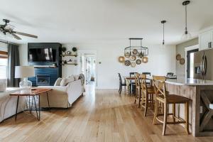 a kitchen and living room with a table and chairs at Afton Awaits in Afton