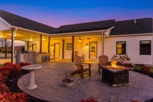 a patio with a fire pit in front of a house at Afton Awaits in Afton