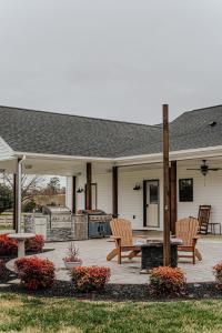 a patio with two wooden chairs and a grill at Afton Awaits in Afton +59 photos