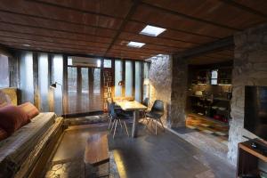 a living room with a bed and a table and chairs at Apart Domus in San Javier
