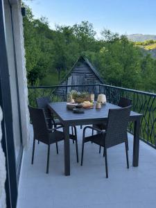 a blue table and chairs on a balcony at Villa Vasilije in Šavnik