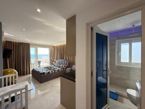 a bedroom with a bed and a bathroom at Eri Apartments in Durrës +69 photos