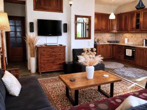 a living room with a couch and a table at Billy's Place in Egina +11 photos