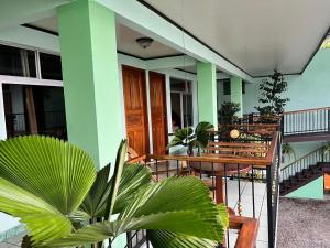 a porch with tables and chairs on a building at Hotel FAS in Fortuna +3 photos