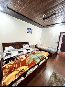 a bedroom with a large bed in a room at Kedar velley in Phata