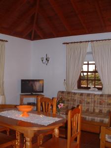 uma sala de estar com uma mesa e um sofá em Casa Los Viñedos A em Fuencaliente de la Palma