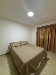 a bedroom with a bed and a window at Duplex Los Molles in Santa Rosa
