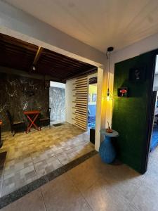a living room with a table and green walls at Amorim's Family Hostel in Olinda