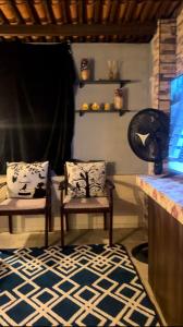 a living room with two chairs and a rug at Amorim's Family Hostel in Olinda +26 photos