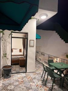 a room with a bed and a table and chairs at Antikhan Han Yusufpaşa in Urfa