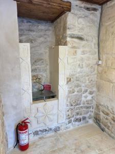 a corner of a stone wall with a fire extinguisher at Antikhan Han Yusufpaşa in Urfa +31 photos