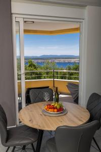 a table with a plate of fruit on a balcony at Apartment Panorama in Jadranovo +18 photos