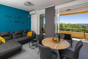 a living room with a couch and a table at Apartment Panorama in Jadranovo