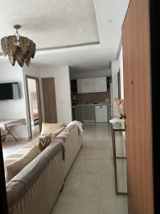a living room with a couch and a kitchen at Zaineb in Hammamet Sud