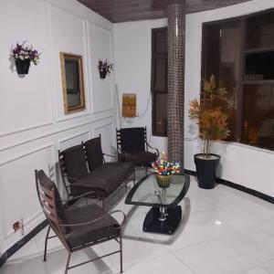 a living room with chairs and a table and a couch at Mouhidiny Log Appart prestige in Dakan