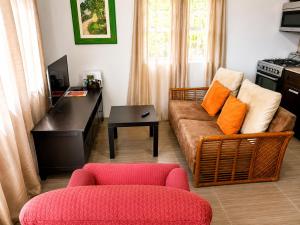 a living room with a couch and a table at Eden Apartments in Basseterre