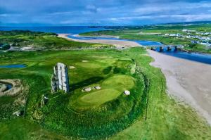 an aerial view of a golf course next to a beach at Fairy Fort View, Lahinch in Carrowauff +19 photos