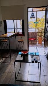 a living room with a coffee table and a table at OLASCOAGA DOS monoambiente in Mendoza +20 photos