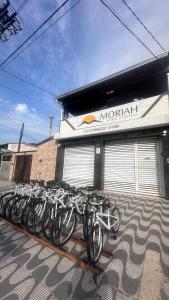 a bunch of bikes parked in front of a building at Moriah Hostel e Pousada in Praia Grande