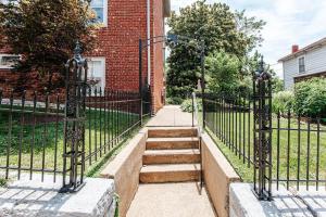 a black iron fence with stairs in front of a building at Red Bud Suite in Staunton