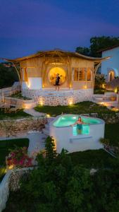 a house with a pool in front of it at night at Camanta Penida - Panoramic Sea & Romantic Escape in Nusa Penida