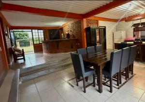 a dining room with a wooden table and chairs at Finca Hotel Montebello in Quimbaya