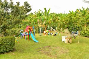 a playground with a bunch of playground equipment in a yard at Finca Hotel Montebello in Quimbaya