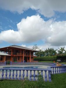 a building with a swimming pool in front of it at Finca Hotel Montebello in Quimbaya