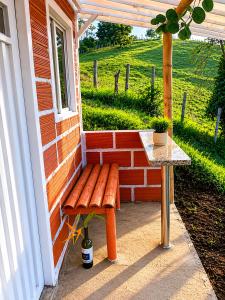 a bench on the side of a house with a table at ECOHostal Las Hamacas El Mirador A Manizales in Villamaría