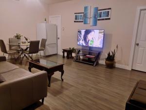 a living room with a couch and a flat screen tv at 1 BDRM 1 BTH Suite with Private Entry in West Kelowna