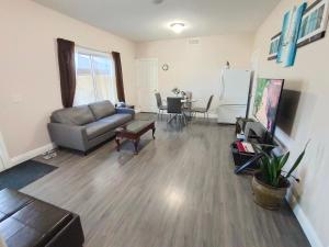 a living room with a couch and a table at 1 BDRM 1 BTH Suite with Private Entry in West Kelowna
