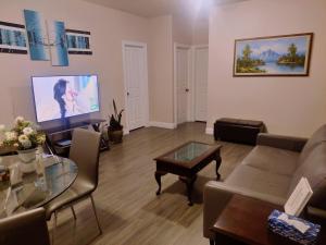 a living room with a couch and a tv at 1 BDRM 1 BTH Suite with Private Entry in West Kelowna +17 photos