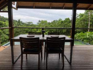 a table and two chairs sitting on a deck at Cape Tribulation Getaway in Cape Tribulation
