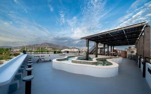 a rooftop deck with a view of the mountains at Casa Del Toro in Barra de Navidad