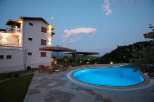 a villa with a swimming pool in front of a building at Panorama Hills Entire Villa in Gjirokastër