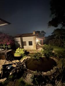 a house at night with a pond in the yard at Refugio del Lago in Envigado +2 photos