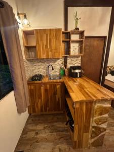 a kitchen with a wooden counter and a sink at Refugio del Lago in Envigado