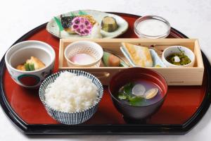 a tray with rice and bowls of food on it at Hotel Bel Air Sendai in Sendai +16 photos