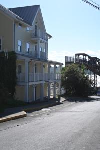 a large white building with a balcony and a bridge at Rhinecliff Hotel in Rhinecliff