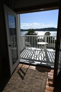 an open door to a balcony with a table and chairs at Rhinecliff Hotel in Rhinecliff +3 photos