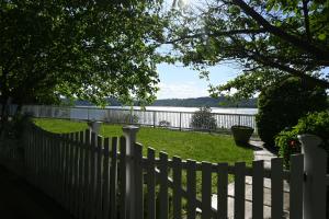 a white picket fence with a view of the water at Rhinecliff Hotel in Rhinecliff