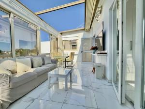 a living room with a couch and a table at Lumière Retreat 2 in Larnaca
