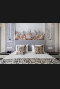a bedroom with a bed with a painting on the wall at St Helens in Bolton