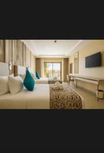 a hotel room with two beds and a flat screen tv at St Helens in Bolton