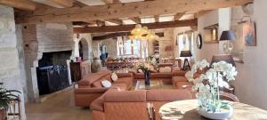 a large living room with couches and a fireplace at Villanath in Bellegarde-sur-Valserine